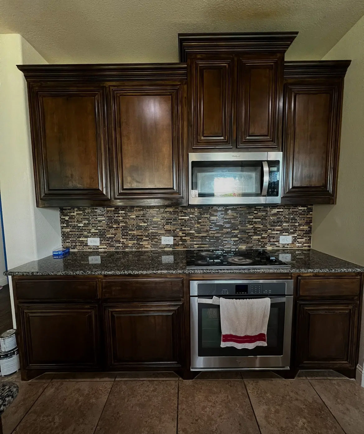 Rich dark stain restoration on raised-panel cabinets